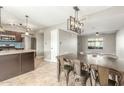 Dining room has an industrial style light fixture, a dining table, and tile floors at 6411 S El Camino Dr, Tempe, AZ 85283