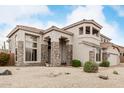 Two-story home with stone accents, desert landscaping, and a covered entryway at 6916 E Trailridge Cir, Mesa, AZ 85207