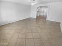 Spacious living room with tile flooring and an open layout leading into the kitchen at 7334 W Comet Ave, Peoria, AZ 85345