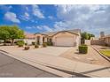 Inviting single-story home with a well-maintained front yard and attached garage at 7839 E Osage Ave, Mesa, AZ 85212