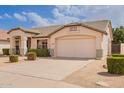 Single-story home featuring a spacious driveway and a two-car garage at 7839 E Osage Ave, Mesa, AZ 85212