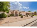 Beautiful single-story home with lush landscaping and a welcoming entrance at 7839 E Osage Ave, Mesa, AZ 85212
