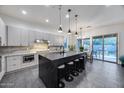 Modern kitchen features a large center island with seating, sleek cabinetry, and stainless steel appliances at 9439 E Trailside Vw, Scottsdale, AZ 85255