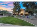 Charming home with beautifully landscaped front yard, mature trees and a welcoming facade at 9760 E San Salvador Dr, Scottsdale, AZ 85258