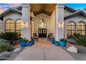Inviting front porch features double doors and colorful potted flowers, perfect for relaxing at 9760 E San Salvador Dr, Scottsdale, AZ 85258