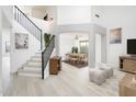Inviting foyer showcasing a staircase with metal railings, an art niche, and easy access to the dining room at 10219 E Le Marche Dr, Scottsdale, AZ 85255