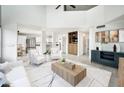 Spacious living room featuring a wet bar, an open floor plan, and easy access to the kitchen and dining area at 10219 E Le Marche Dr, Scottsdale, AZ 85255