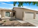 Single story home with a desert landscape and a three-car garage at 10960 E Monte Ave # 169, Mesa, AZ 85209