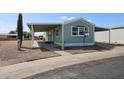 Charming exterior featuring a covered parking area, desert landscaping, and freshly painted facade at 11275 N 99Th Ave # 170, Peoria, AZ 85345