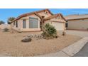 A well kept house with desert landscaping and a 2 car garage at 11540 W Sonoran Ct, Surprise, AZ 85378