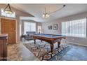 Spacious game room with a pool table, carpet, and natural light at 11540 W Sonoran Ct, Surprise, AZ 85378