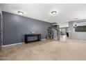 Spacious living room with a console table, cat tree, neutral carpet, and gray walls at 11737 W Robin Dr, Sun City, AZ 85373