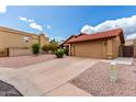 Attractive single-story home featuring a red tile roof, neutral stucco, and low-maintenance landscaping at 12436 S 38Th Pl, Phoenix, AZ 85044
