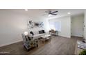 Comfortable living room has lots of natural light with a soft couch and colorful chair at 1302 E Maryland Ave # 15, Phoenix, AZ 85014