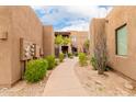 A walkway between buildings features lush landscaping and staircase to upper units at 13300 E Via Linda -- # 1065, Scottsdale, AZ 85259