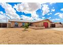 Well-maintained single-story home featuring arched windows and desert landscaping at 1437 W Renee Dr, Phoenix, AZ 85027