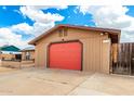 Attached one-car garage with a red door and desert landscaping in the front yard at 1437 W Renee Dr, Phoenix, AZ 85027