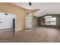 Spacious living room featuring plush carpeting, neutral paint, and ample natural light from large windows at 17943 N Woodrose Ave, Surprise, AZ 85374