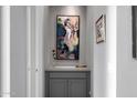Elegant hallway featuring custom cabinets, sophisticated artwork, and subtle lighting at 18502 N 98Th Way, Scottsdale, AZ 85255