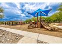 Community playground featuring a variety of play structures, slides, and shaded seating areas at 18502 N 98Th Way, Scottsdale, AZ 85255