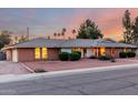 Classic single-story home with a brick facade, a well-kept lawn, and an attached garage at 2148 E Cairo Dr, Tempe, AZ 85282