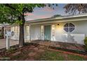 Charming home featuring a quaint front entrance with a colorful door and decorative window detail at 222 N Miller St, Mesa, AZ 85203
