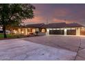 Expansive view showcasing the home's architectural style and a spacious three car driveway, taken at dusk at 226 W Ranch Rd, Tempe, AZ 85284