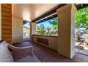 Covered porch featuring brick flooring, decorative brick, and a serene outdoor view at 226 W Ranch Rd, Tempe, AZ 85284