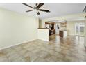 Open concept living and dining area featuring tile flooring, ceiling fan, and kitchen access at 23 W Fairmont Dr, Tempe, AZ 85282