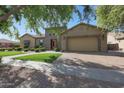 Charming single-story home featuring a well-manicured lawn, lush greenery, and a brick pathway leading to the front door at 2873 E Los Altos Rd, Gilbert, AZ 85297