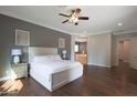 Spacious main bedroom featuring wood floors, a ceiling fan, and an ensuite bath with a soaking tub at 2873 E Los Altos Rd, Gilbert, AZ 85297