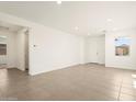 Open concept living room with recessed lighting, tile floors, and bright natural light at 35459 N Seedling St, San Tan Valley, AZ 85144