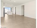 Inviting living room featuring neutral tile flooring and bright, natural light at 35459 N Seedling St, San Tan Valley, AZ 85144