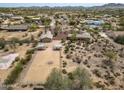 Aerial view showcasing the property with surrounding desert landscaping, horse corral and mountain views at 39606 N 3Rd Ave, Phoenix, AZ 85086