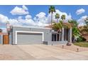 Lovely single-story home featuring mature palms, a two-car garage, and low-water landscaping at 412 W Curry St, Chandler, AZ 85225