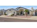 Charming single-Gathering home featuring a two-car garage, desert landscaping, and a basketball hoop at 4362 W Behrend Dr, Glendale, AZ 85308