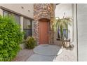 Inviting entryway with a stylish front door, stone accents, and lush landscaping at 4777 S Fulton Ranch Blvd # 1029, Chandler, AZ 85248