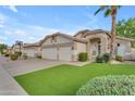 Inviting home featuring a wide driveway, spacious two-car garage, and lush landscaping at 4809 W Erie St, Chandler, AZ 85226