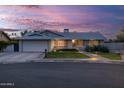 Inviting home showcasing lush green lawn, mature landscaping, and decorative window accents at 5206 S Clark Dr, Tempe, AZ 85283
