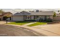 Beautiful residence with a pristine lawn, paved walkway, and desert-friendly plants at 5206 S Clark Dr, Tempe, AZ 85283