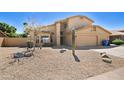 Charming two-story home with a well-maintained front yard featuring desert landscaping and a two-car garage at 5513 E Grovers Ave, Scottsdale, AZ 85254