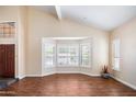 Bright living room with large windows, plantation shutters, and hardwood floors, offering a comfortable space at 5513 E Grovers Ave, Scottsdale, AZ 85254