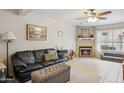 Comfortable living room with a fireplace, tile floors, and a large leather couch at 5808 E Brown Rd # 140, Mesa, AZ 85205