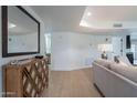Cozy living room featuring wood floors, a decorative cabinet, and ample natural light at 711 N 22Nd St, Mesa, AZ 85213