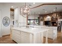 Spacious kitchen with dual islands, stone fireplace, and natural light streaming through large windows at 7788 E Morning Vista Ln, Scottsdale, AZ 85266