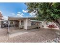 Exterior home view highlighting the patio, outdoor furniture, and desert-style yard at 8323 E Deep Canyon Ct, Mesa, AZ 85208