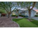Charming single-story home with mature landscaping and a well-manicured artificial lawn at 9015 E Altadena Ave, Scottsdale, AZ 85260