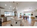 Open-concept kitchen with granite counters, stainless appliances, and a center island at 9015 E Altadena Ave, Scottsdale, AZ 85260