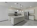 Bright kitchen features stainless steel appliances, granite countertops, an island, and recessed lighting at 1564 W Redwood Ln, Phoenix, AZ 85045