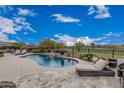 Relaxing pool area with comfortable lounge chairs and serene views of the surrounding landscape at 19633 N 264Th Ave, Buckeye, AZ 85396
